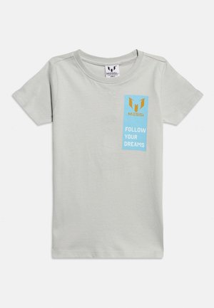 Ανοιχτό γκρι κοντομάνικο μπλουζάκι με ένα μπλε κάθετο ορθογώνιο στο στήθος, πορτοκαλί λογότυπο "Messi" και λευκό κείμενο "ΑΚΟΛΟΥΘΗΣΕ ΤΑ ΟΝΕΙΡΑ ΣΟΥ."