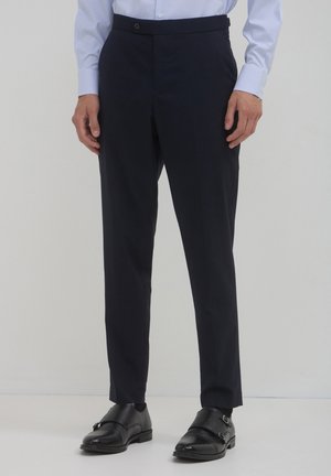 Marineblaue, taillierte Hosen mit schmaler Passform, aus glattem Stoff gefertigt, mit flachem Frontteil, seitlichen Taschen und einem dezenten Knopfverschluss.