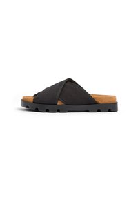 Sandal in tessuto nera con cinturini incrociati, finitura in suede e soletta in sughero sagomata. La suola in gomma presenta un motivo a intagli.