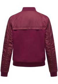 Burgundy bomber jacket with knit cuffs and collar, featuring a smooth, shiny upper body and textured fleece lower back.