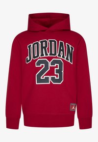 Felpa rossa con cappuccio che presenta la scritta "JORDAN" e il numero "23" in lettere bianche e nere. Realizzata in tessuto morbido, include una patch con il logo sull'orlo.