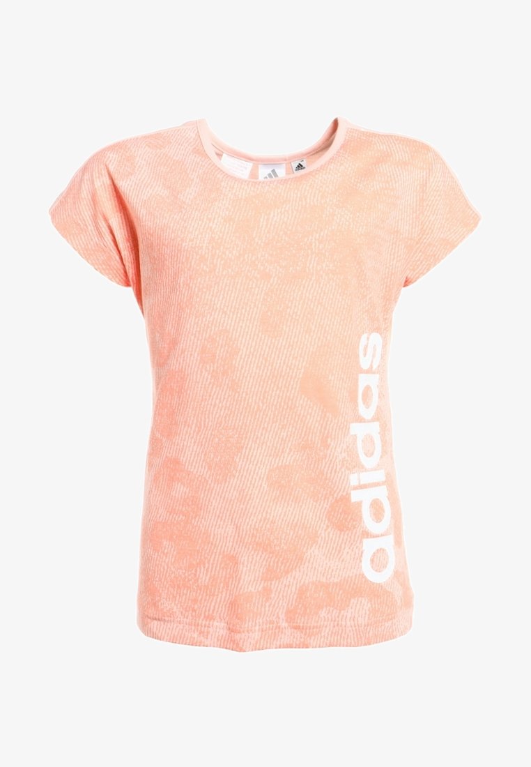 Meruňkové tričko s texturovaným vzorem, krátké rukávy a kulatým výstřihem. Na boku je vytištěno bílé logo "adidas".