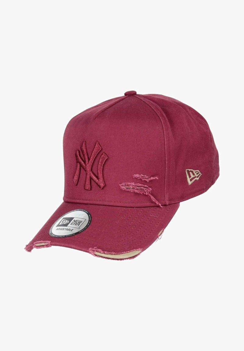 Red cotton baseball cap with embroidered NY logo, distressed detailing on the brim, and an adjustable strap at the back.