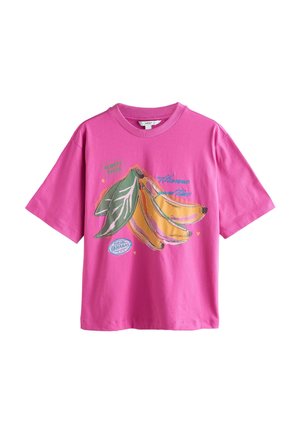 Bright pink short-sleeve t-shirt with graphic of three yellow bananas and green leaves, featuring text "Harvest good times" and small hearts.