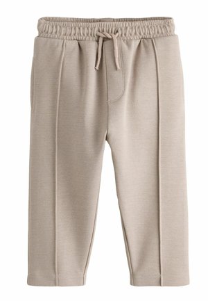 Beige Hose mit elastischem Bund, vorderer Nahtverzierung und gebundener Kordel, gefertigt aus strukturiertem Stoff, auf weißem Hintergrund gezeigt.