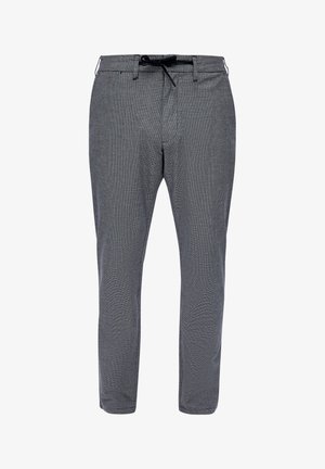 Checkered pants in black and white, featuring a fitted design, elastic waistband with drawstring, and a smooth fabric texture.