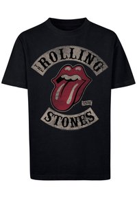 Sort bomulds T-shirt med et slidtegnede design, der har en rød tunge og teksten "THE ROLLING STONES" i hvid og sort, grundlagt i 1978.