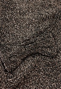 Tessuto nero con una superficie strutturata, caratterizzato da macchie metalliche dorate e bianche sparse, creando un motivo sottile in tutto il tessuto.