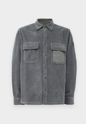 Gray corduroy shirt featuring a button-up front, two chest pockets, and a textured surface with vertical ribbing.