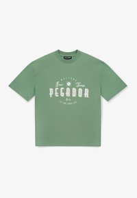 Green cotton t-shirt with short sleeves, featuring graphic text "WELCOME FINER THINGS PEGADOR Italy TO THE GOOD LIFE" in contrasting colors.