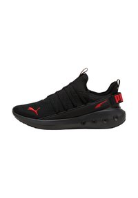 Scarpe sportive nere con tomaia in rete, lacci elastici e dettagli rossi. Presentano una suola ammortizzata con pod arrotondati per una migliore aderenza.
