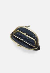 Black leather coin purse with a gold-tone clasp and two compartments, featuring a navy blue interior with white star patterns.