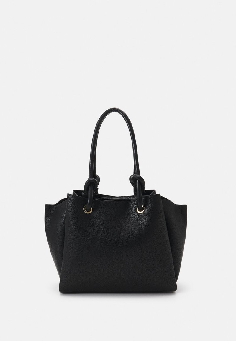 Sac à main en cuir noir texturé avec deux poignées arrondies et des anneaux en métal doré fixant les poignées au corps du sac.