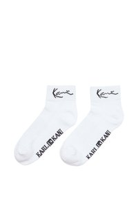 Bílé bavlněné ponožky do kotníků s černým logem "Kani" na vrchní části a "KARL KANI" na boku s jemným žebrováním.