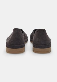 Pantofi slip-on din suede negru cu un design de profil jos și talpă din cauciuc. Vederea din spate evidențiază textura netedă și forma rotunjită.