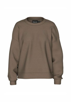 Smeđa majica s dugim rukavima, s okruglim izrezom, spuštenim ramenima i rebrastim manžetama. Izrađena od mekog, glatkog materijala bez vidljivih uzoraka ili hardverskih detalja.