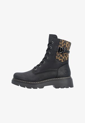 Botte noire à lacets avec semelle épaisse, empiècement imprimé léopard à la cheville, sangle décorative à boucle et surpiqûres contrastantes autour de la semelle.