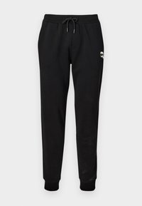 Schwarze Sweatpants mit elastischem Bund und verstellbarem Kordelzug. Mit gerippten Bündchen und einem kleinen Grafikdetail am Oberschenkel.