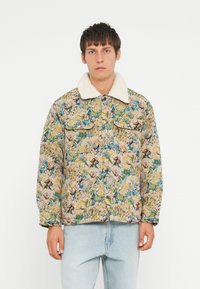 Floral-patterned jacket with a sherpa collar, featuring vibrant colors like blue, yellow, and green. Two chest pockets, durable fabric.