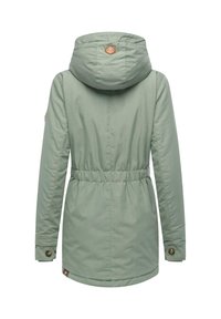 Light green parka with a cinched waist, hood, and buttoned cuffs. Features a tan logo badge and a smooth, textured fabric.
