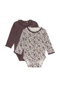 Två långärmade bodysuits: en enhetlig mörklila med volangkrage, den andra vit med mörk blommönster och volangärmar.