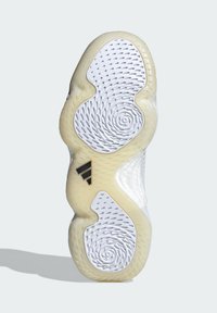 Suela de zapato con una textura ondulada, predominantemente blanca con una suela de goma beis. Incluye acentos de logotipo negros y patrones perforados.