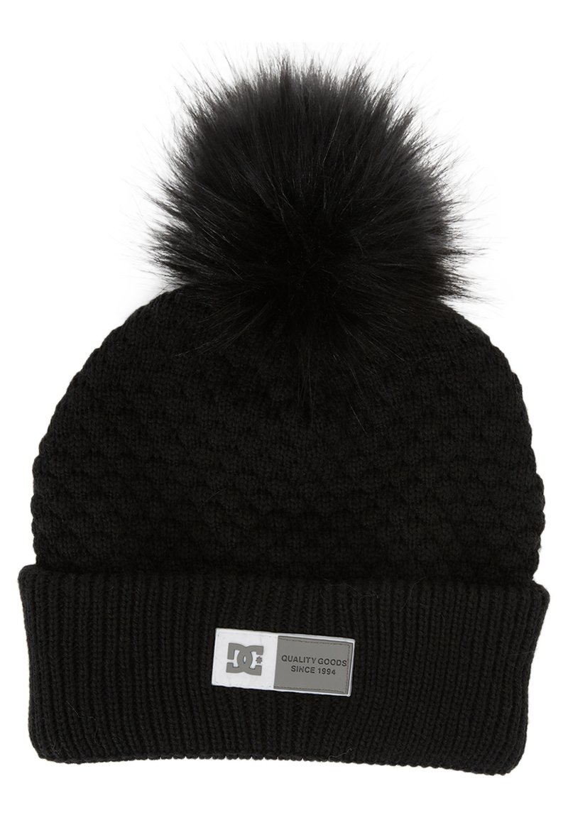Black knit beanie with a fluffy pom-pom on top, featuring a textured pattern and a folded ribbed cuff. Includes a rectangular logo patch.