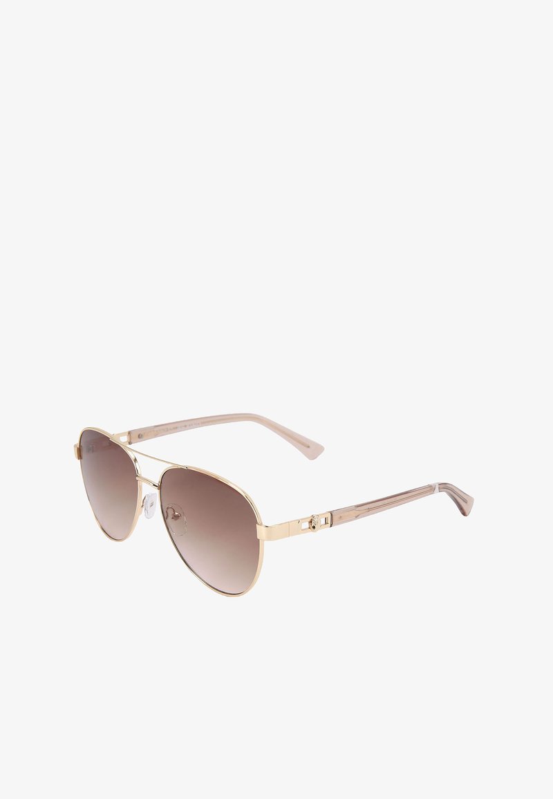 Lunettes de soleil avec une monture en métal doré de forme aviateur, verres dégradés marron et branches en plastique texturé rose clair avec des accents de matériel décoratifs.