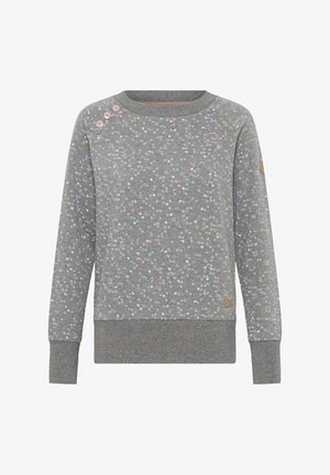 Pelēks džemperis ar rozā un ziliem plankumiem. Tam ir ribota apļa kakla un aproču apdare, kā arī dekoratīvas pogas uz pleca.