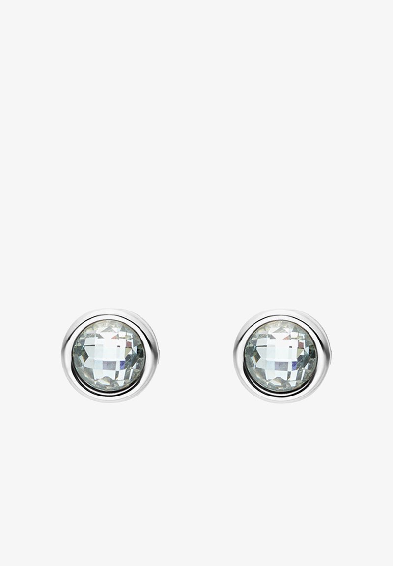 Boucles d'oreilles rondes à clous avec pierres facettées transparentes, serties dans un métal poli de couleur argentée. Surface lisse avec une brillance subtile, design minimaliste.