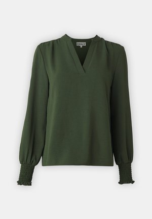 Tamsiai žalia bluzonė su V formos iškirpte, ilgomis rankovėmis ir susigūžusiomis apykaklėmis, pagaminta iš lengvos medžiagos su glotnia tekstūra.