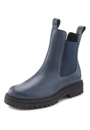 Botte Chelsea en cuir bleu marine avec semelle en caoutchouc noire épaisse, panneau latéral élastique et languettes de traction à l'avant et à l'arrière du col.