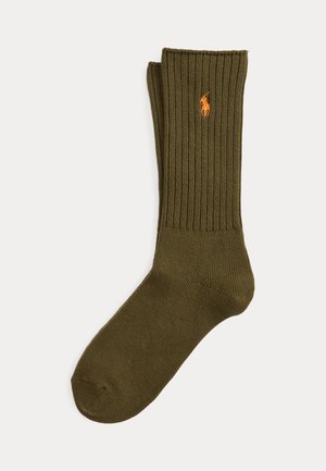 Olive green ribbed crew sock with orange embroidered polo player logo on cuff, displayed flat against a white background.