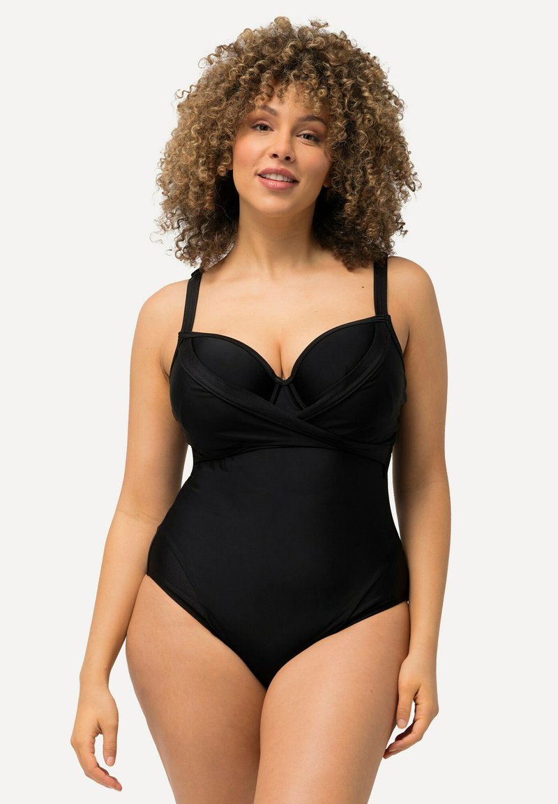 Maillot de bain noir une pièce avec soutien-gorge à armatures, tissu texturé, bretelles ajustables et design à l'avant croisé.