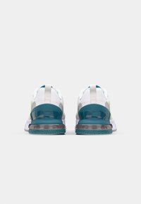 Rear view of athletic shoes featuring a multicolor upper, mesh fabric, padded collar, and a thick teal sole with a textured pattern.