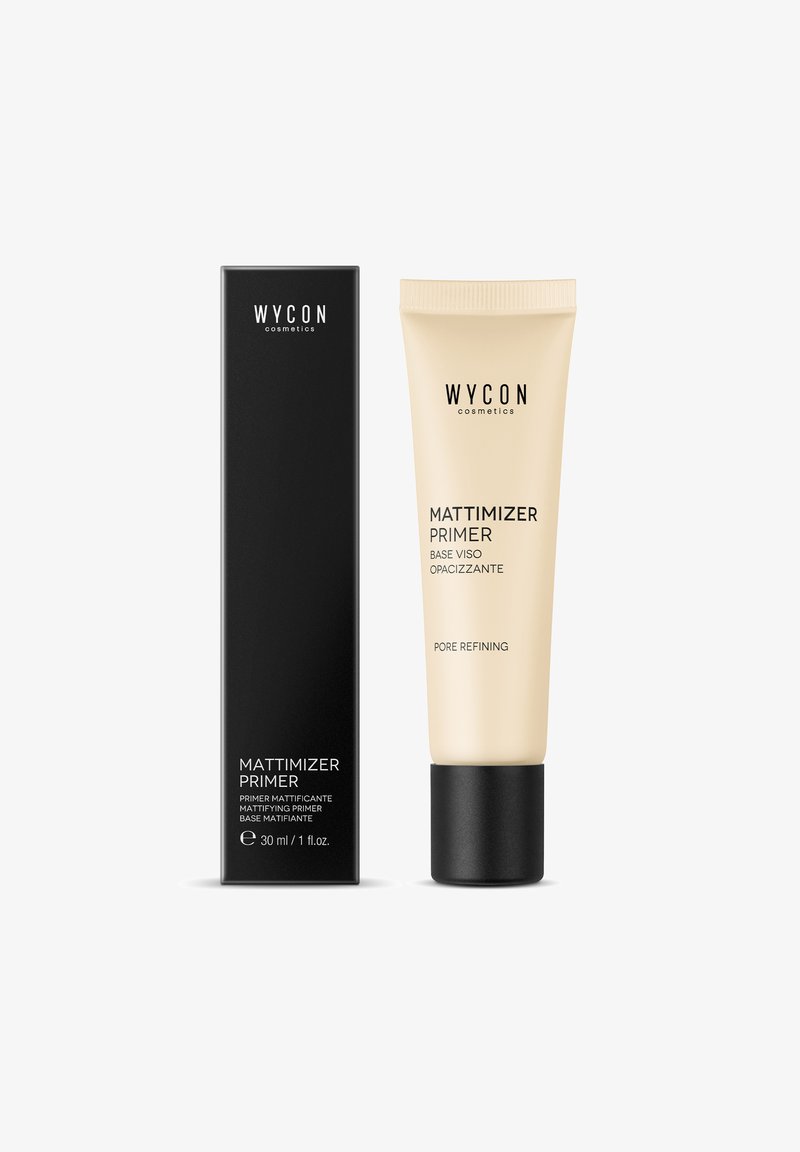 Primer Mattimizer in un tubo beige con un tappo nero accanto a una scatola nera alta. Entrambi presentano un marchio in testo bianco. Indicata dimensione di 30 ml.