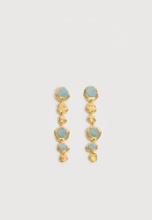 Boucles d'oreilles goutte en or avec des pierres bleues irrégulières reliées verticalement dans un design en cascade sur fond blanc.