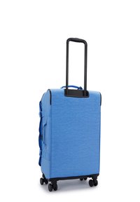 Blue rolling suitcase with a textured finish, retractable black handle, and four wheels. Side compression straps for secure packing.