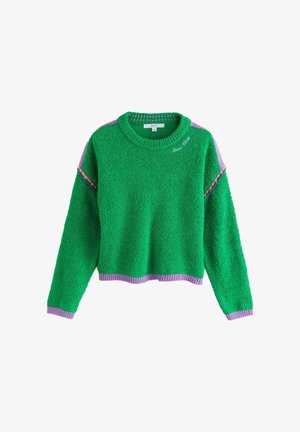 Green fuzzy sweater with lilac trim on cuffs, hem, and shoulders, featuring embroidered "Good vibes" text near the collar.