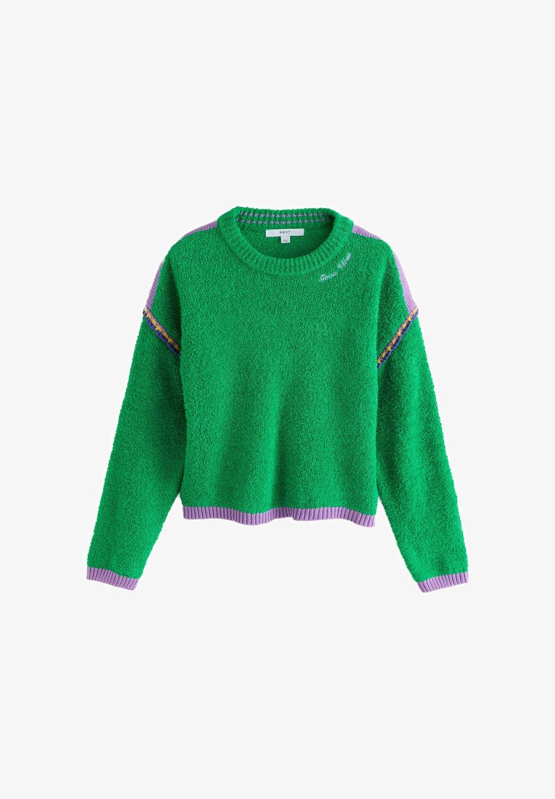 Pull vert duveteux avec bordure lilas aux poignets, à l'ourlet et aux épaules, avec le texte brodé « Bonnes ondes » près du col.