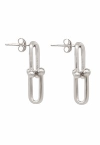 Boucles d'oreilles en métal argenté en forme de trombone allongé, avec des accents arrondis au centre et un fermoir à tige pour un port sécurisé.