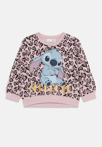 Rózsaszín pulóver leopárdmintával, rajzfilmszerepl�ővel. Az alakja alatt arany betűkkel a "STITCH" felirat található. Puha anyag, kerek nyakú.
