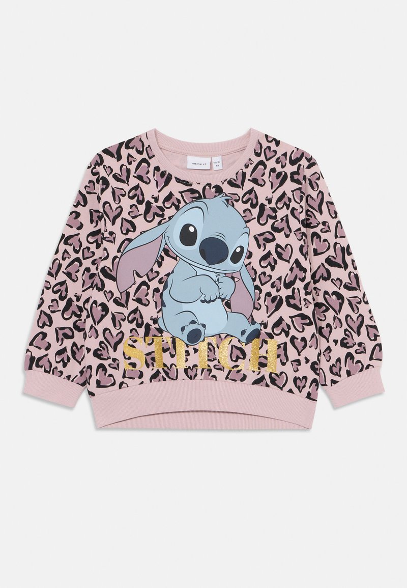 Rózsaszín pulóver leopárdmintával, rajzfilmszereplővel. Az alakja alatt arany betűkkel a "STITCH" felirat található. Puha anyag, kerek nyakú.