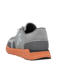 Gray athletic shoe with a textured suede upper, mesh accents, and an orange rubber sole. Features a prominent logo and cushioned heel.