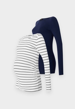 Två långärmade graviditetströjor; en marinblå och en vit med svarta ränder. Båda har ett mjukt tyg och en figursydd design för komfort.