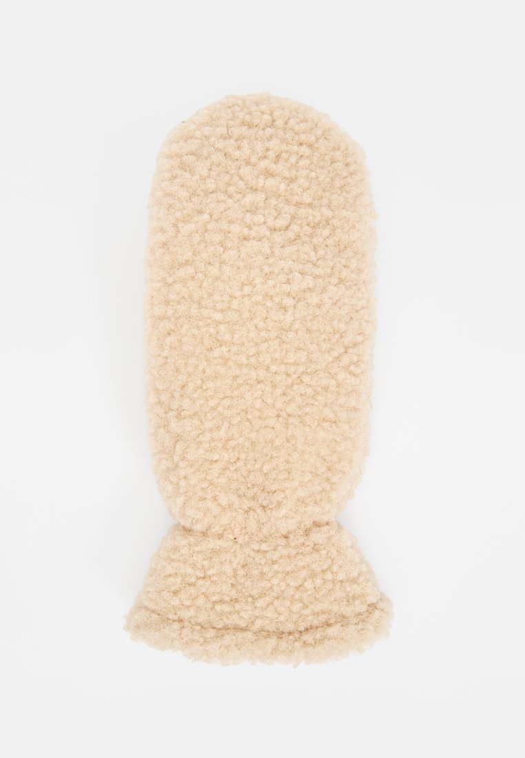 Manopla de color beige y texturizada, hecha de material suave. Forma redondeada y suave con un puño en la base. Sin herrajes o adornos visibles.