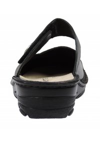 Black sandal with a textured leather strap and padded insole. Open-back design features a Velcro closure for adjustable fit. Rubber sole.