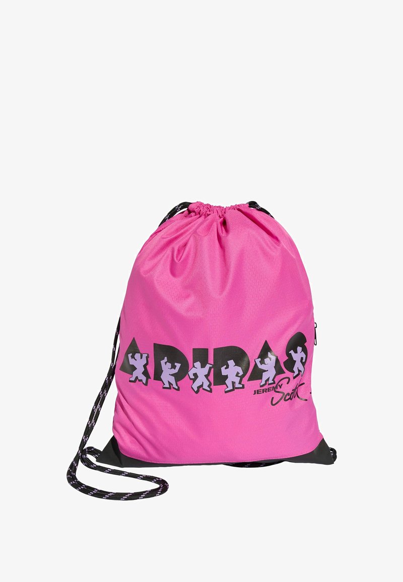 Pink drawstring bag with black accents, logo, and cartoon figures. Made of lightweight material with a smooth texture and adjustable straps.