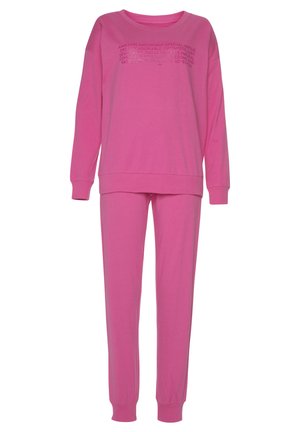 Pink cotton loungewear set featuring a long-sleeve top with round neck and front text detailing, and matching tapered pants with elastic cuffs.