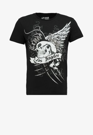 T-shirt en coton noir avec un graphique frontal d'un crâne ailé, le texte "Los Angeles" et des motifs complexes en blanc et argenté.